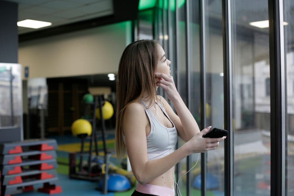 Woman with gym anxiety standing in gym — getting started tips